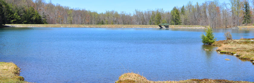 The Ligonier Township reservoir on a spring day, the dam and spillway tower across the far shore